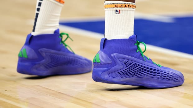 Minnesota Timberwolves guard Anthony Edwards' blue and green adidas sneakers.
